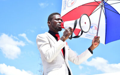 Ugandan politician Robert Kyagulanyi Ssentamu, also known as Bobi Wine, campaigns with a megaphone. Before they could reach the campaign venue in Kumi District, he and his campaign team were tear gassed and subjected to numerous obstacles by Ugandan security forces on November 15, 2020. (photo credit: Lookman Kampala)
